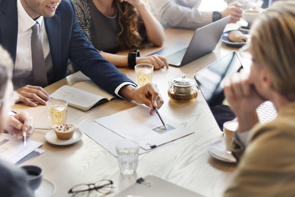 Client sitting around a table discussing fiances at wHealth Advisors office